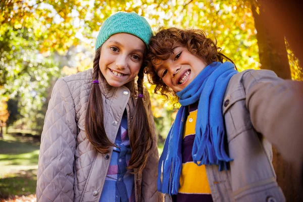 Cheerful siblings taking selfie in park — Stock Photo, Image