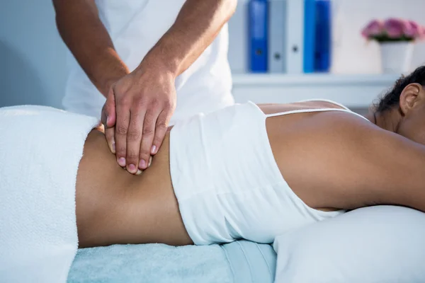 Physiotherapist giving back massage to a woman — Stock Photo, Image