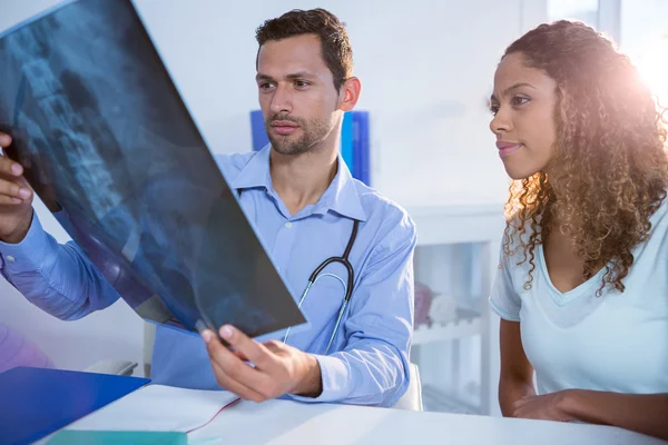 Fisioterapista che spiega la radiografia al paziente — Foto Stock