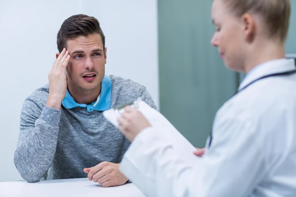 Patient discussing his problem with female patient