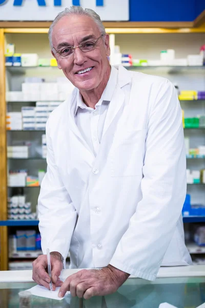 Pharmacist writing prescriptions for medicines — Stock Photo, Image