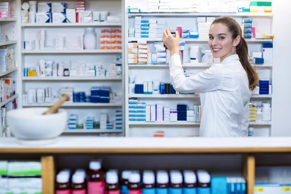 Pharmacist checking a medicine in pharmacy — Stock Photo, Image