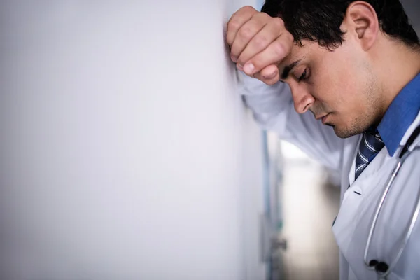 Trauriger Arzt lehnt sich an die Wand — Stockfoto