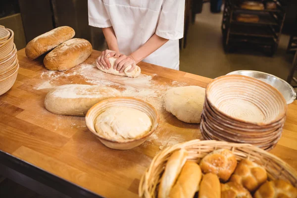 Panettiere femminile impastando una pasta — Foto Stock