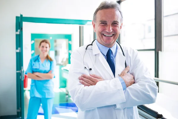 Portrait of doctor and nurse standing with arms crossed — Stock Photo, Image