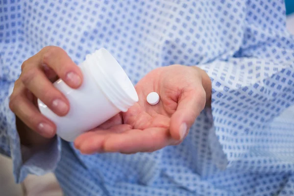 Senior patients hands holding medicine — Stock Photo, Image