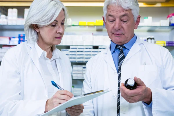 Pharmacists checking and writing prescription for medicine — Stock Photo, Image