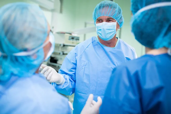 Surgeons interacting with each other — Stock Photo, Image