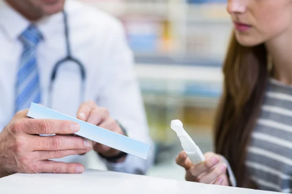 Customer and pharmacist reading pregnancy test — Stock Photo, Image