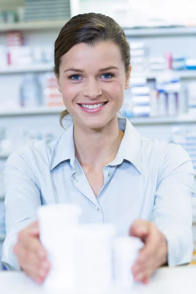 Pharmacist holding medicine container — Stock Photo, Image