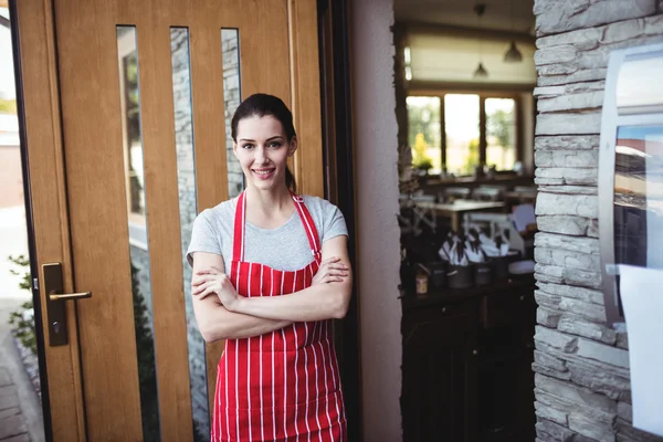 Female baker standing with arms crossed Stock Photo