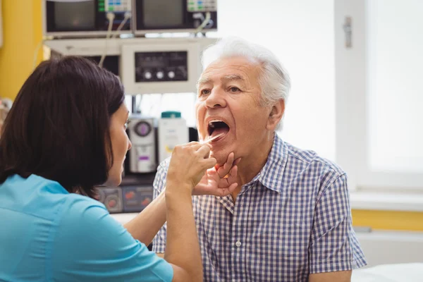 Doctor examining a patient Stock Picture