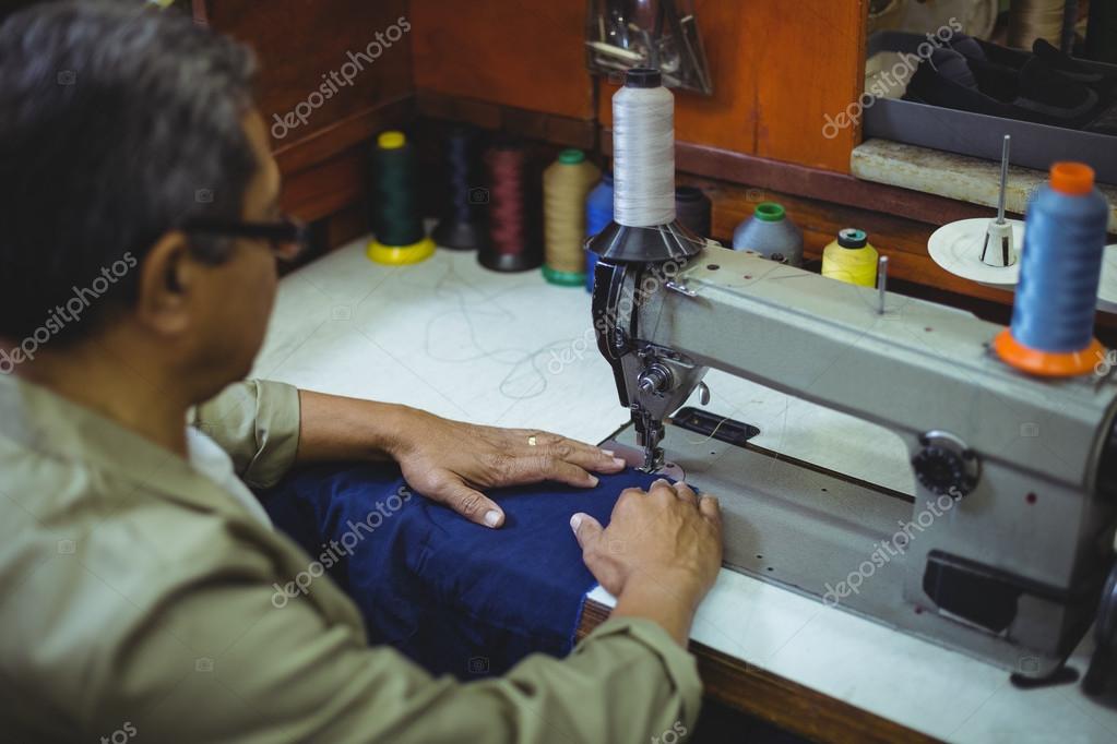 Shoemaker using sewing machine Stock Photo by ©Wavebreakmedia 123959488