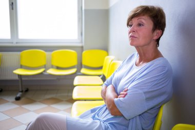 Patient sitting in a waiting room clipart