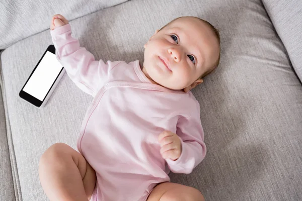 Baby lying on sofa in living room