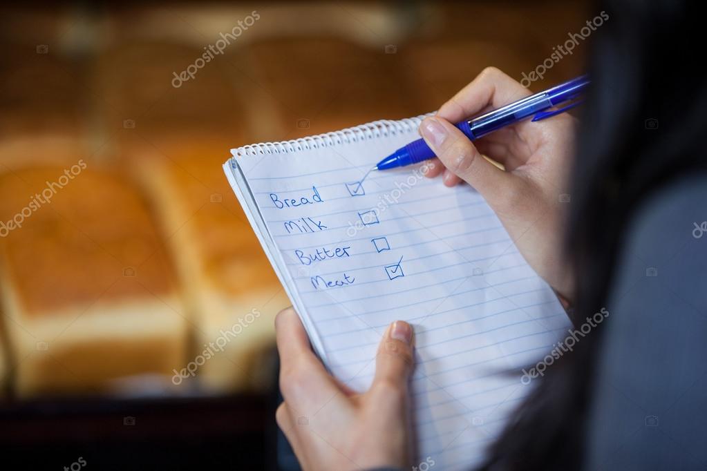 Woman marking on checklist — Stock Photo © Wavebreakmedia 125048652