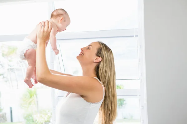 Mãe brincando com seu bebê na sala de estar — Fotografia de Stock