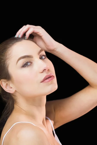 Woman posing against black background — Stock Photo, Image