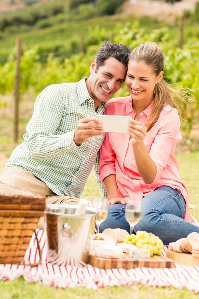 Happy couple using mobile phone — Stock Photo, Image