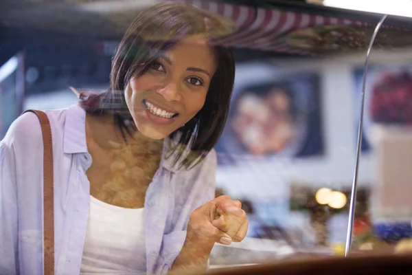 Excited woman pointing at display — Stock Photo, Image