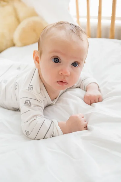 Baby lying on baby bed Royalty Free Stock Photos