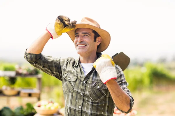 Farmer carrying shovel — Stock Photo, Image