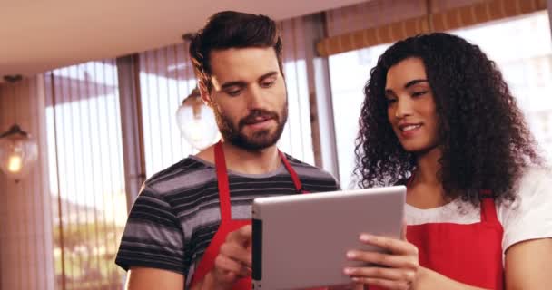 Waiter and waitress using tablet — Stock Video