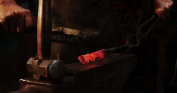 Blacksmith using wire brush on hot iron — Stock Video