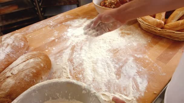 Baker spreading dough on counter — Stock Video