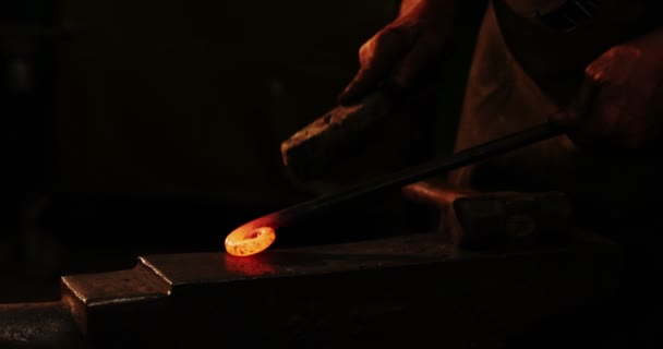 Blacksmith using wire brush on hot iron — Stock video