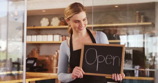 Waitress showing slate with open sign — Stock Video