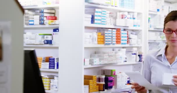 Pharmacist holding medicine and prescription — Stock Video