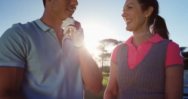 Couple interacting while playing golf — Stock Video