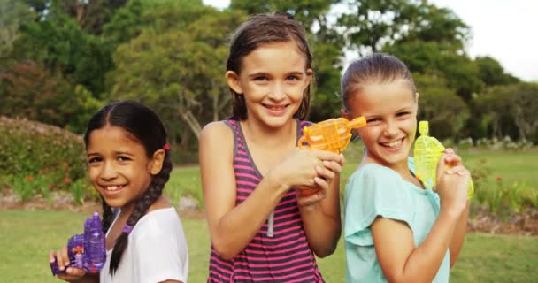 Smiling girls holding water gun — Stock Video