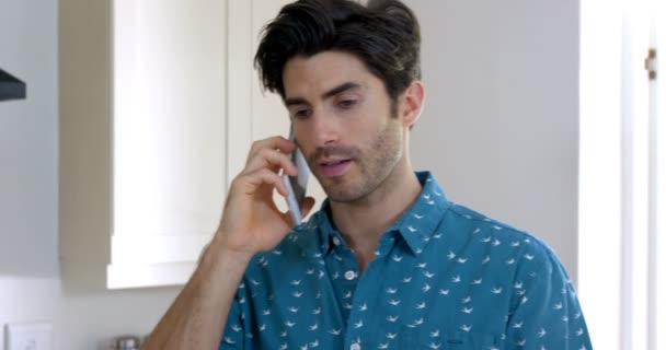 Man talking on phone in kitchen — Stock Video