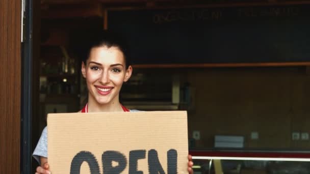 Female baker holding open signboard — Stock Video