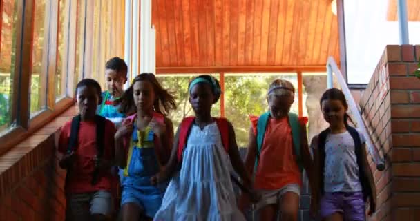 Group of kids walking down stairs — Stock Video