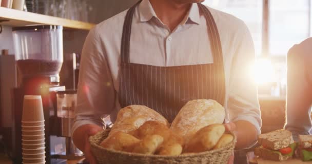 Waiter and waitress holding buns and sandwiches — Stockvideo