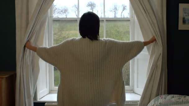 Mujer abriendo cortinas de ventana — Vídeos de Stock