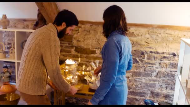 Man showing earthenware lamp to a woman — Stock Video