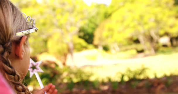 Girl dressed up in a fairy costume in garden — Stock Video