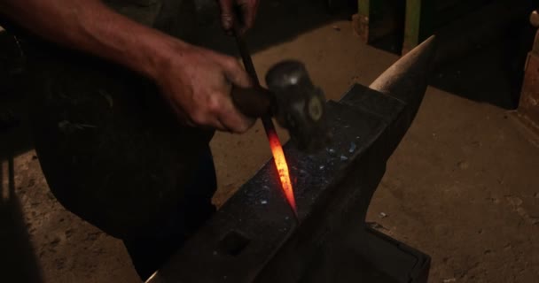 Bir demir çubuk üzerinde çalışan demirci — Stok video