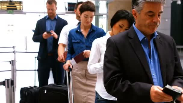 Commuters standing in queue for check-in — Stock Video