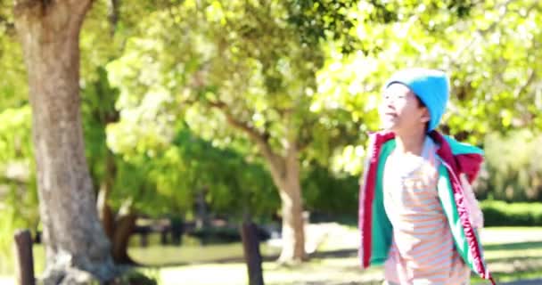 Smiling boy playing in park — Stock video