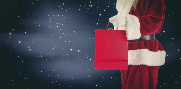 Santa carries red gift bag — Stock Photo, Image