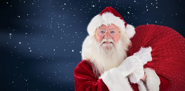 Jolly Santa bär hans säck — Stockfoto