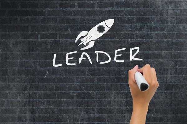 Hand writing leader on wall — Stock Photo, Image