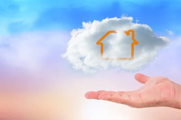 Hand carrying house in a cloud — Stock Photo, Image