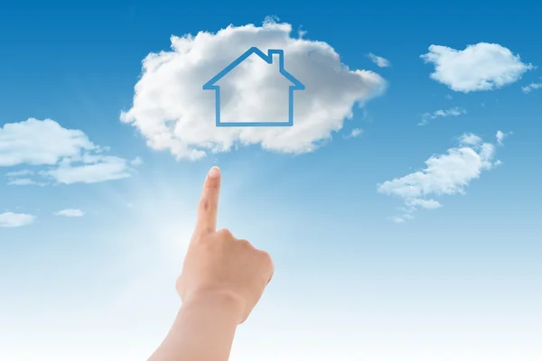 Hand pointing a cloud with house inside — Stock Photo, Image