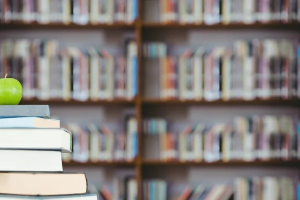 Stack of books and green apple — Stock Photo, Image